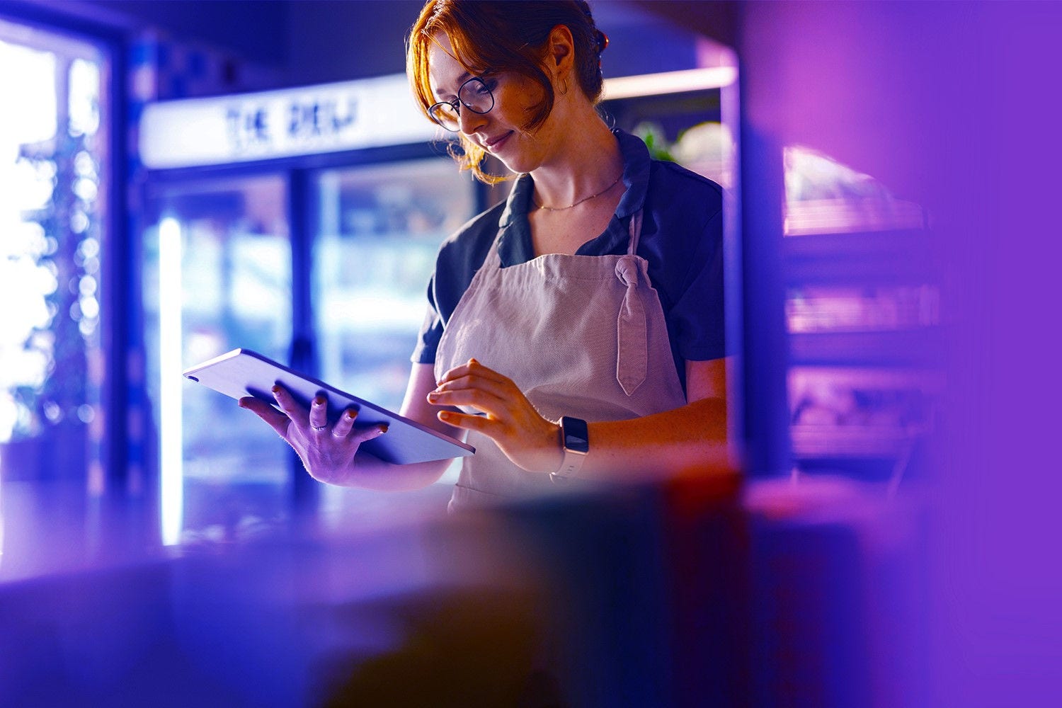 Grocer checking on tablet computer Grocer checking on tablet computer