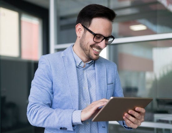 Man with spectacles with a tablet Man with spectacles with a tablet