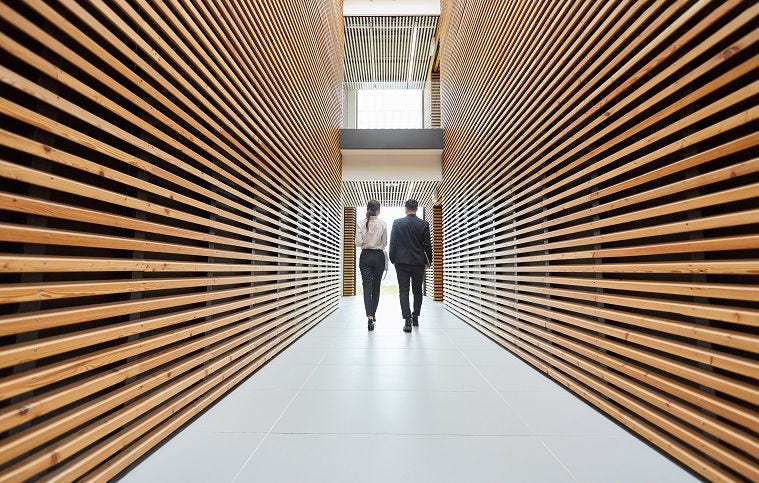 Man woman walking in corridor
